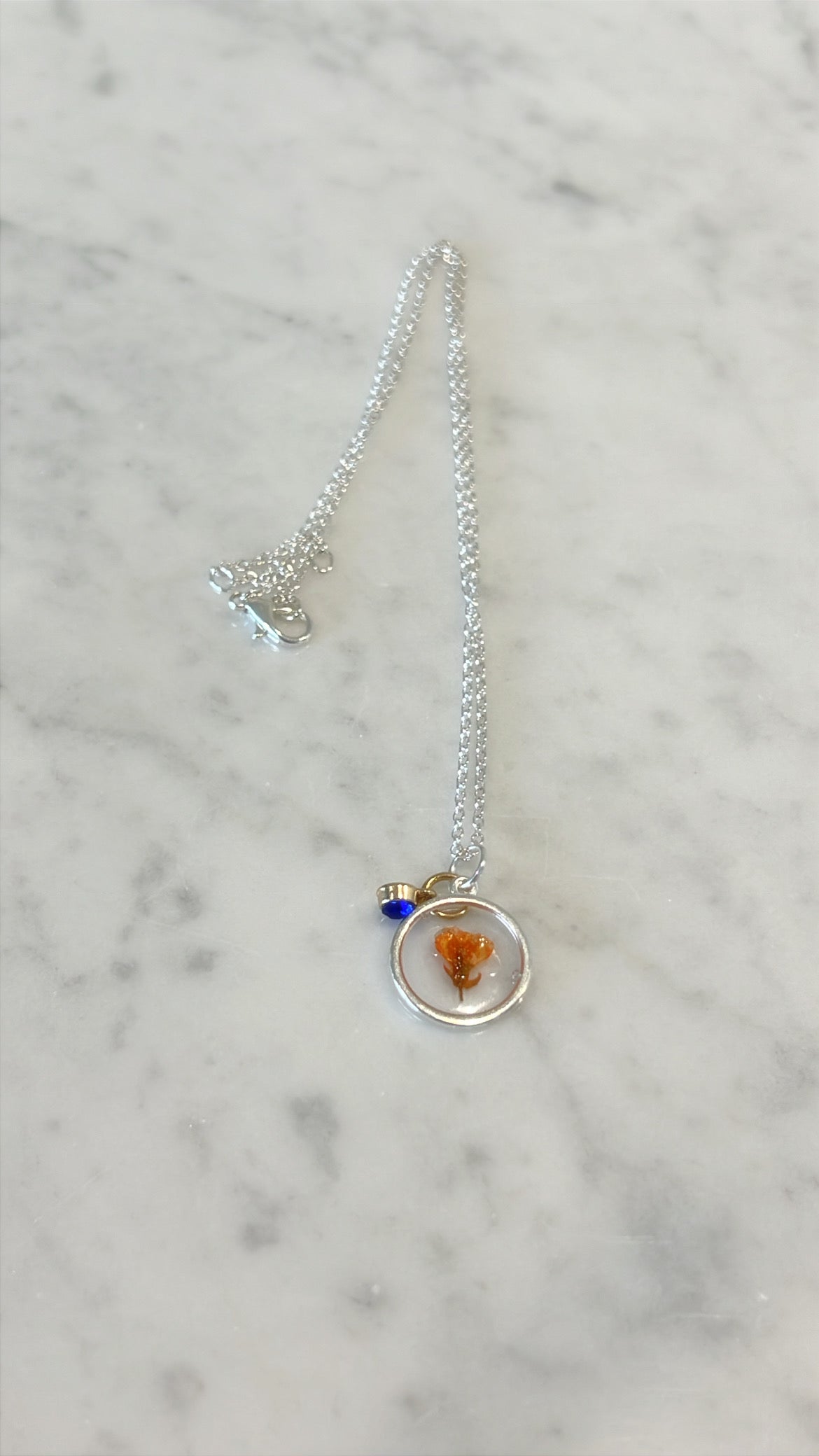 Small poppy with blue gem