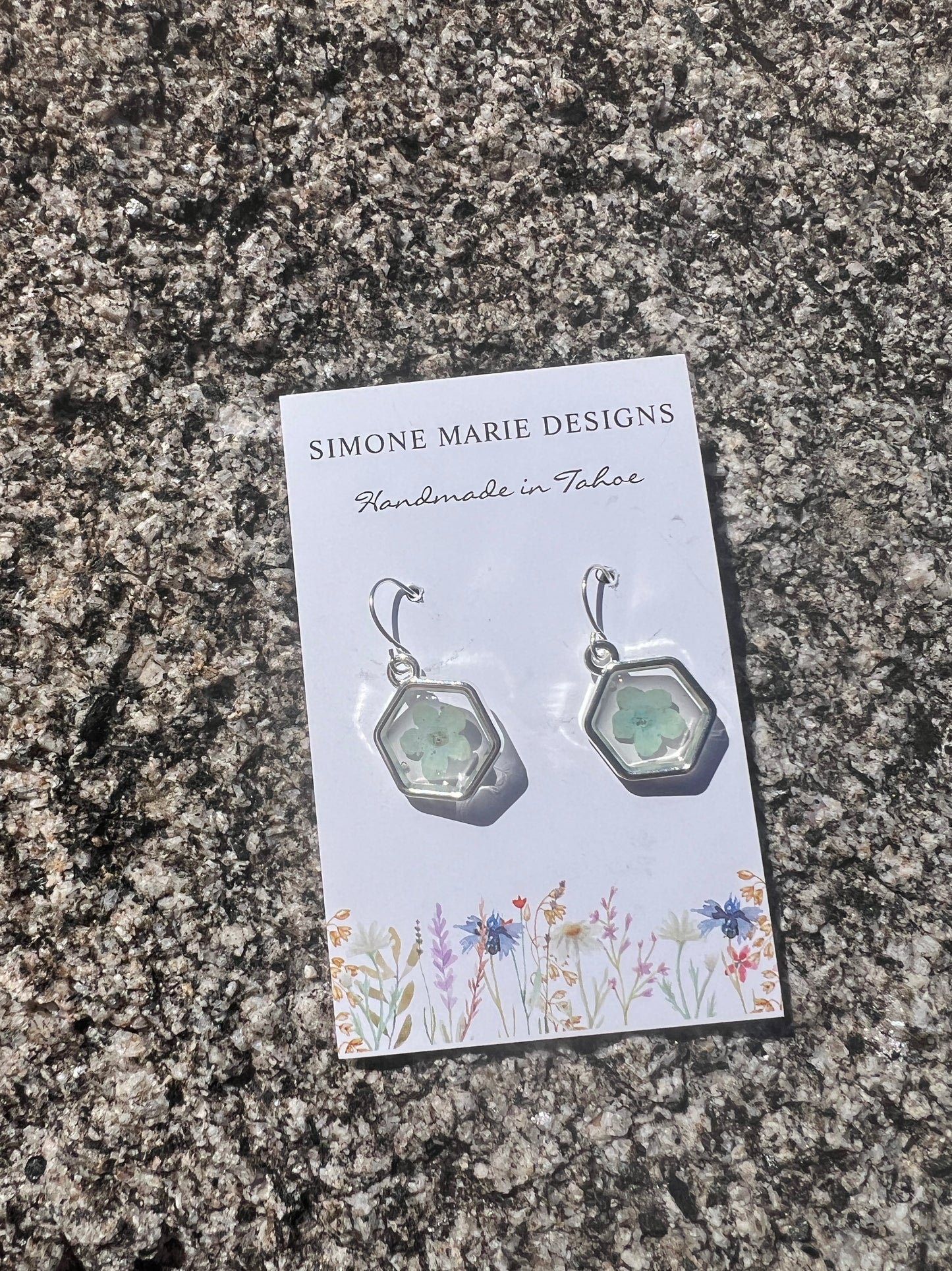 Baby blue forget-me-not in silver hexagon